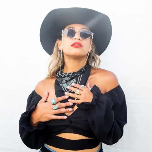 Very cool woman wearing western fashion including a cowboy hat, bandana and turquoise jewelry