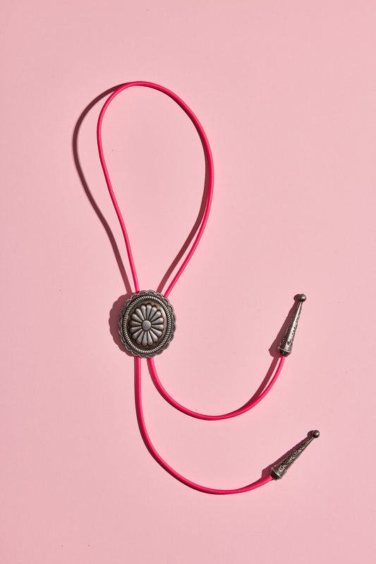 Handmade bolo tie with bright coloured cord and silver turquoise-look hardware, displayed on neutral background – western costume jewellery made in Australia