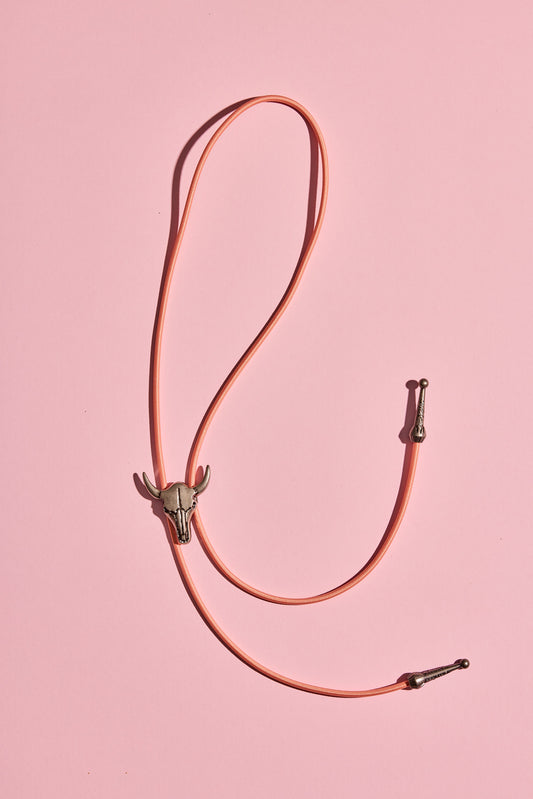 Handmade bolo tie with bright coloured cord and silver turquoise-look hardware, displayed on neutral background – western costume jewellery made in Australia