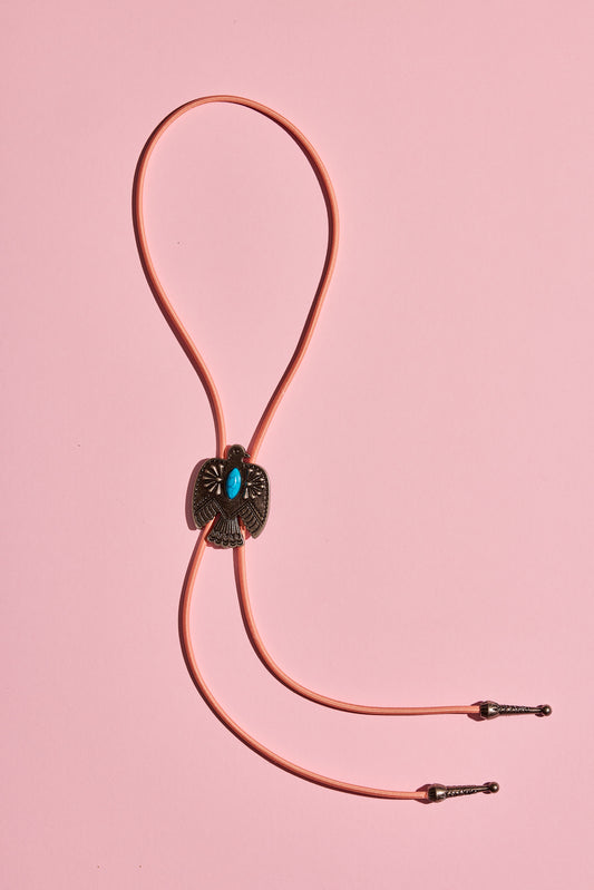 Handmade bolo tie with bright coloured cord and silver turquoise-look hardware, displayed on neutral background – western costume jewellery made in Australia